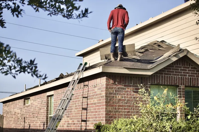 Professional roofer working on a residential roof in Oakland Square